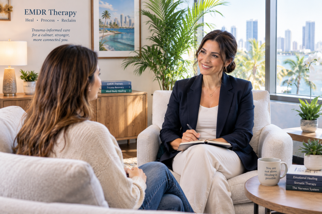 A qualified EMDR therapist warmly meets with a prospective client in a bright, modern South Florida therapy office, creating a welcoming and professional environment that emphasizes trust, emotional safety, and trauma-informed care.